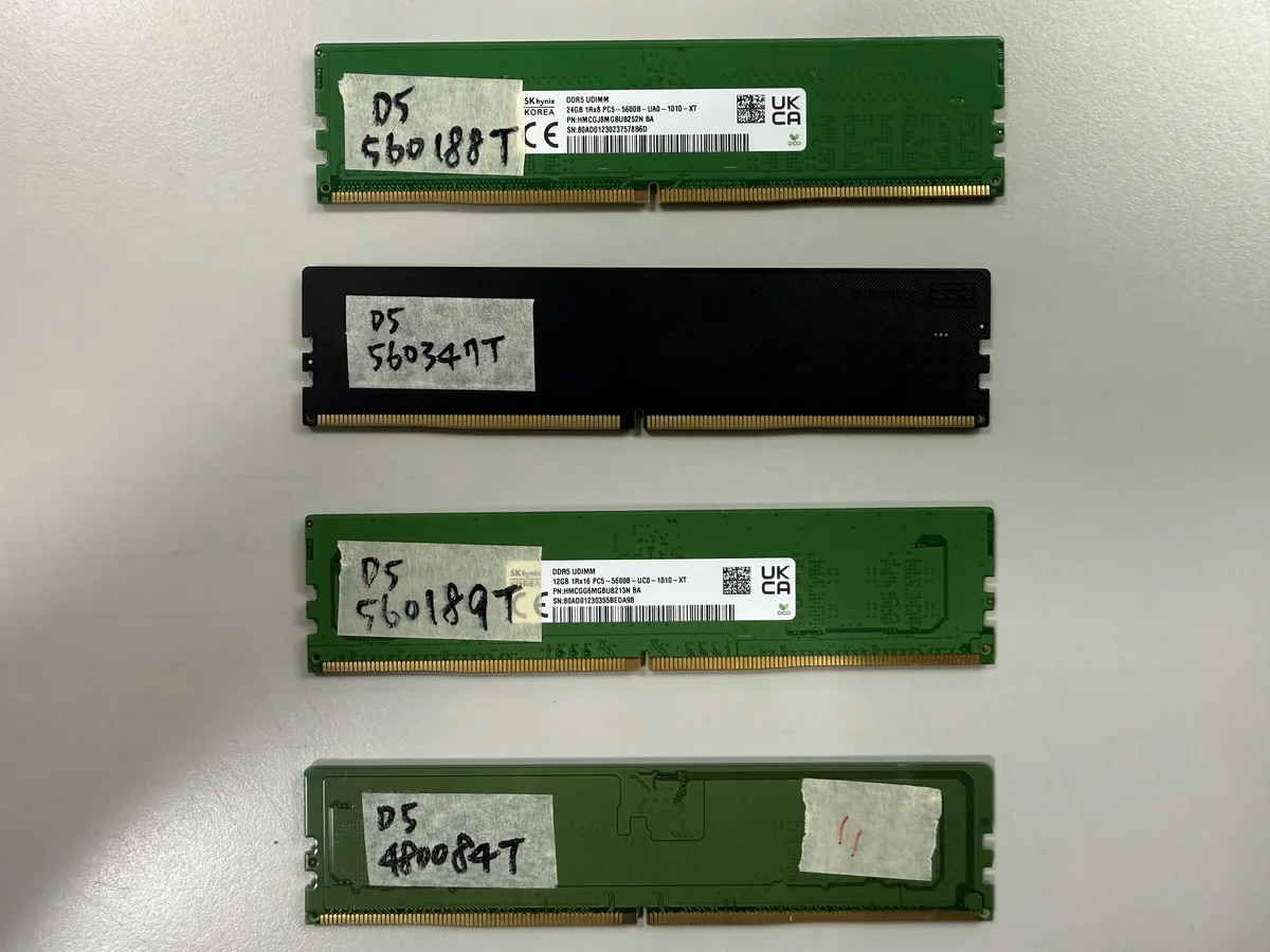 Four SK hynix DDR5 UDIMM memory modules with labels showing specific codes such as'560188T' and'480084T' are displayed on a white surface.