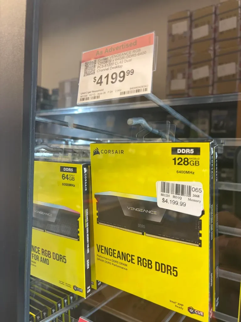 A shelf displays Corsair Vengeance RGB DDR5 memory modules with one labeled 128GB (2x64GB) and priced at $4,199.99.
