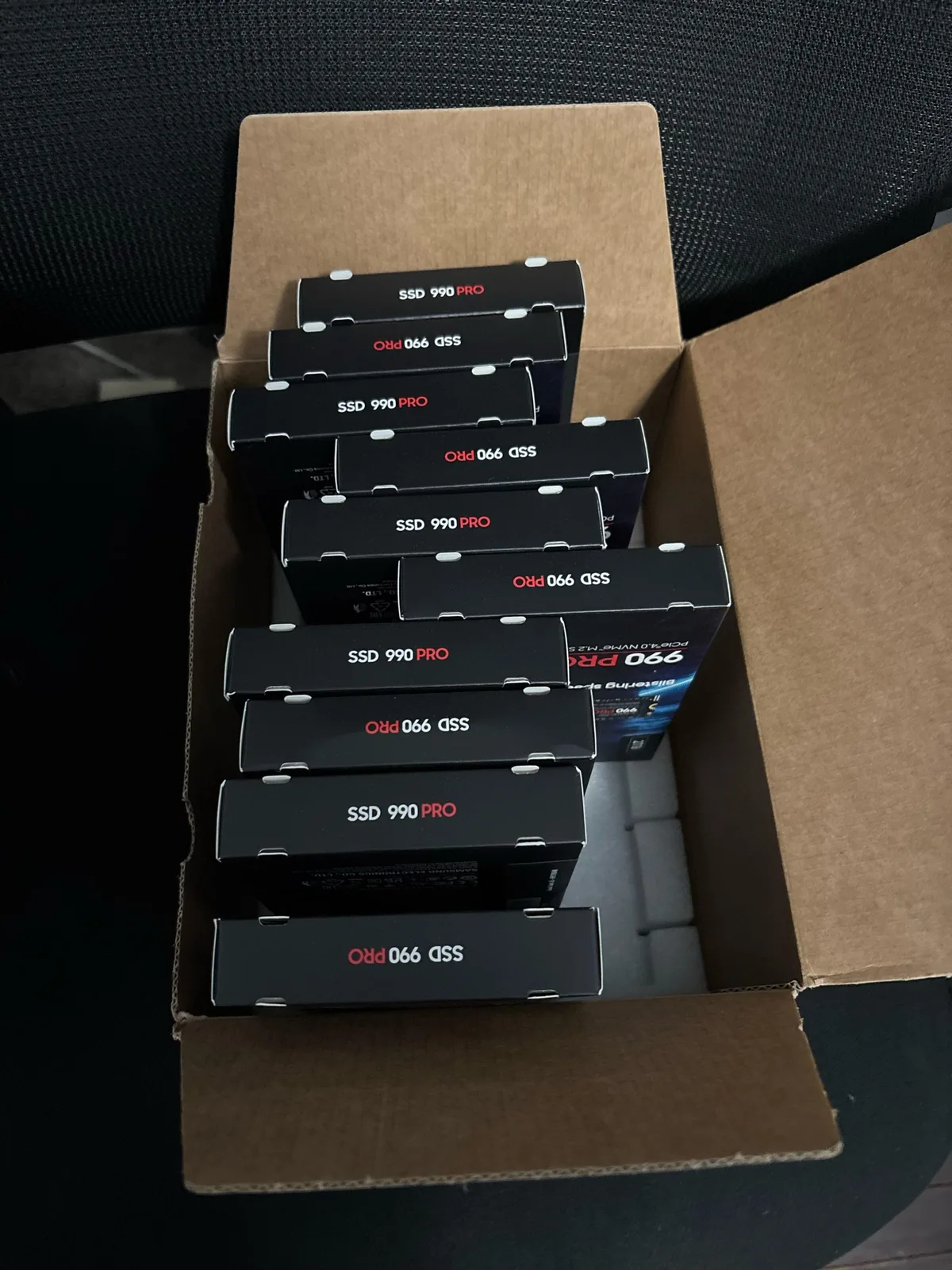 A cardboard box containing multiple Samsung SSD 990 PRO packages.