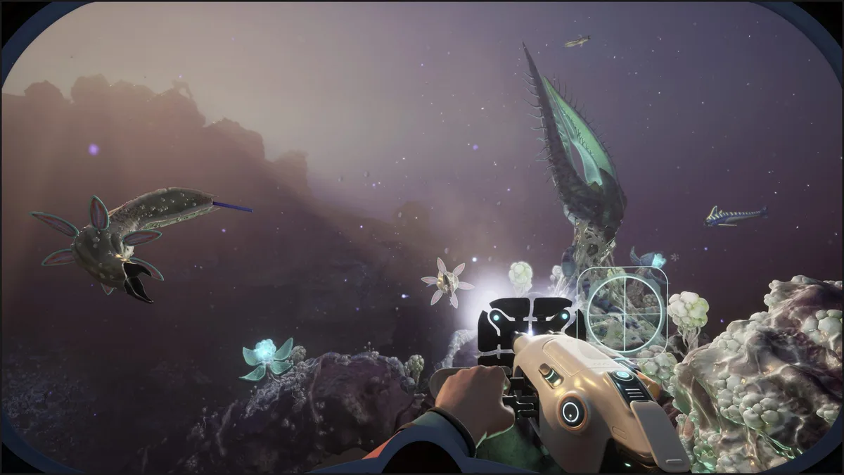 A character in the game'Subnautica 2' explores an underwater environment using a handheld device while encountering various alien sea creatures.