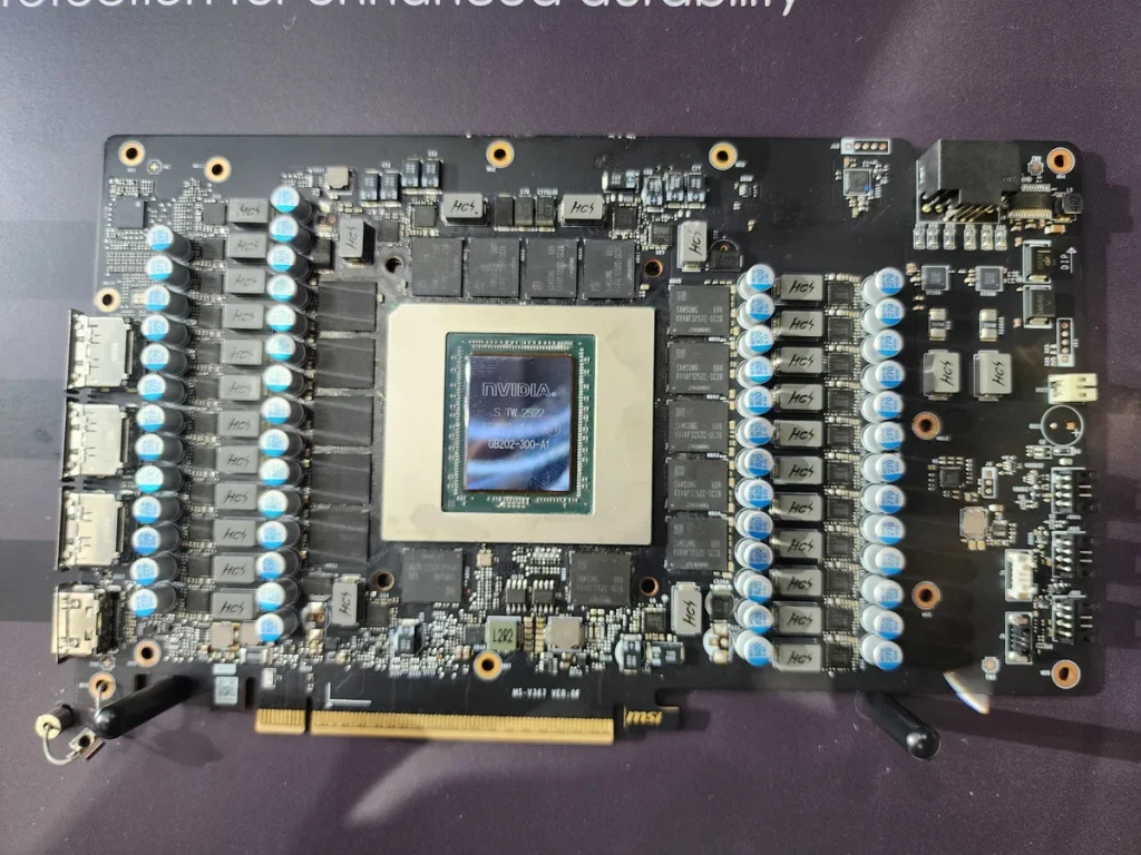A close-up view of a graphics card featuring an NVIDIA chip labeled 'NVIDIA 68202-300-A1' on a dark circuit board with numerous capacitors and connectors.