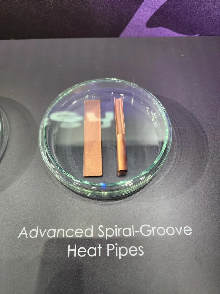 Two copper heat pipes are displayed on a clear dish with the text 'Advanced Spiral-Groove Heat Pipes' below them.