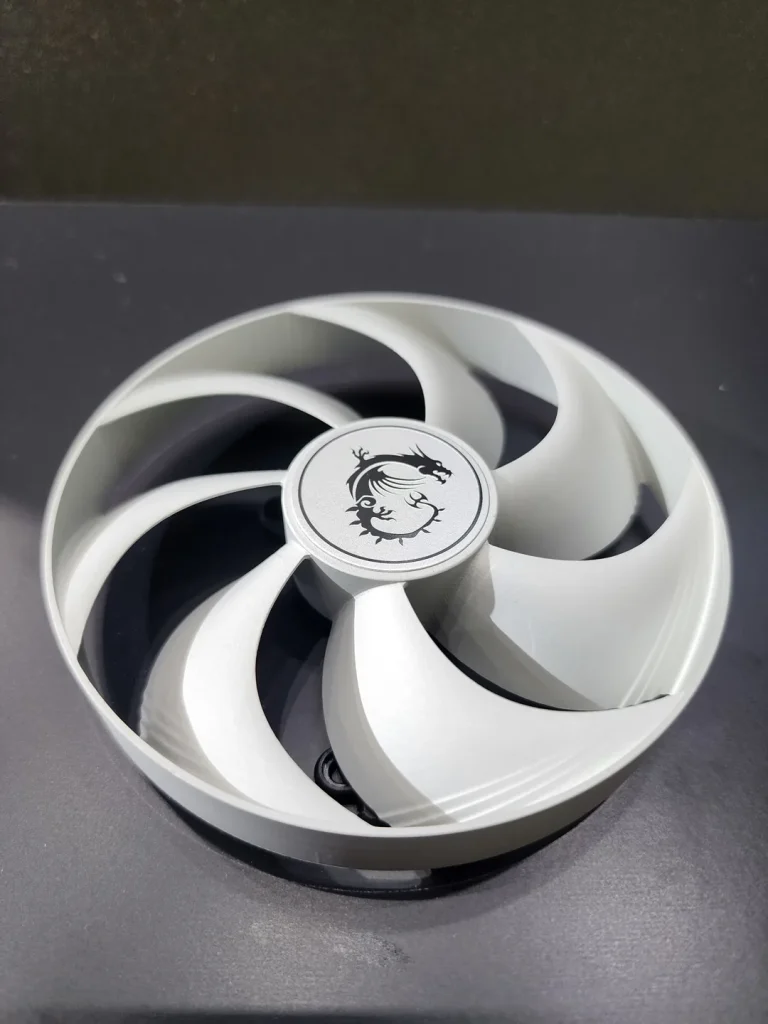 A cooling fan featuring the MSI dragon logo on its center, displayed on a dark surface.