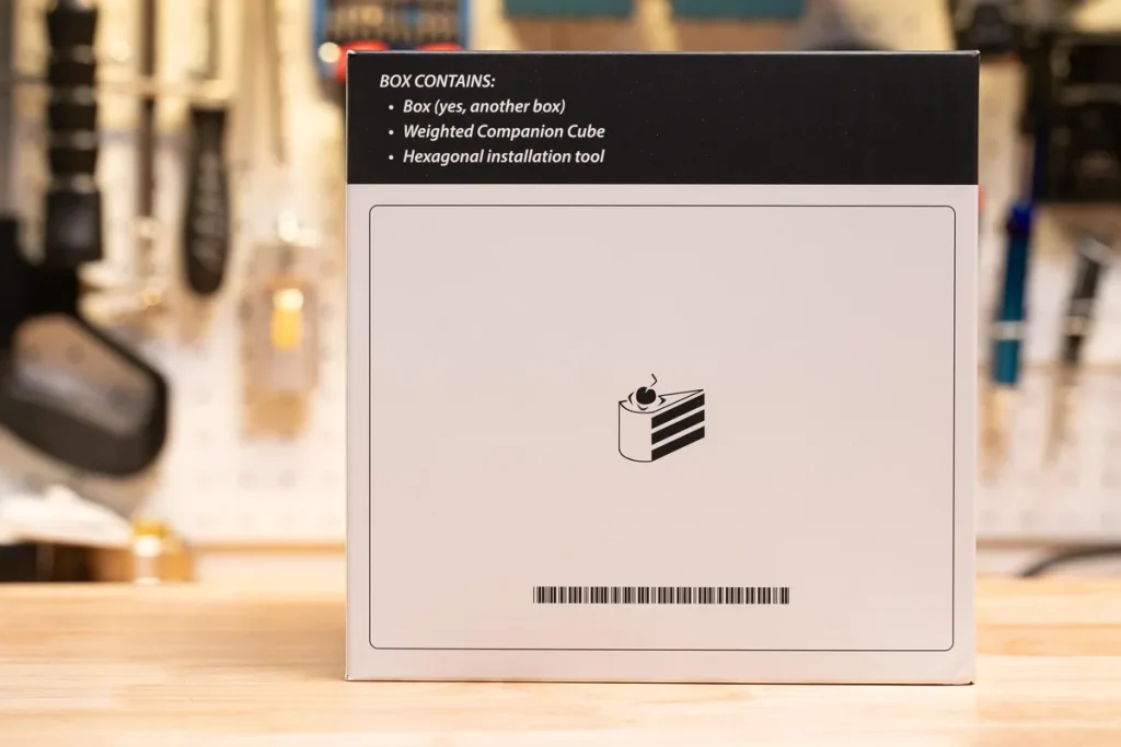 The barcode reads “THE CAKE IS A LIE”.