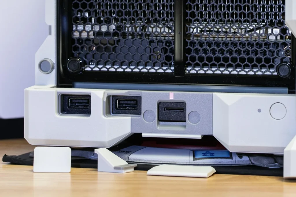 The USB port covers have squishy rubber-ish covers held in by friction and expansion; the microSD cover is magnetically attached.