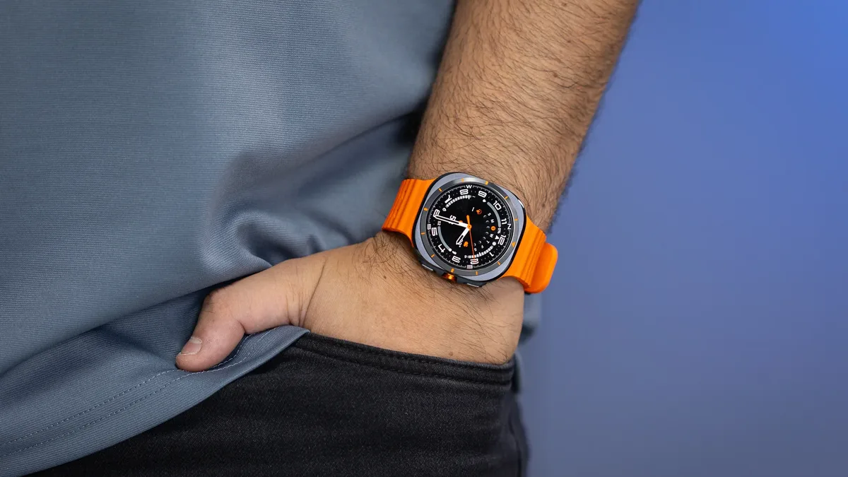 Galaxy Watch Ultra 2 leak — A person wears a Galaxy Watch Ultra (2024) with an orange band on their wrist.