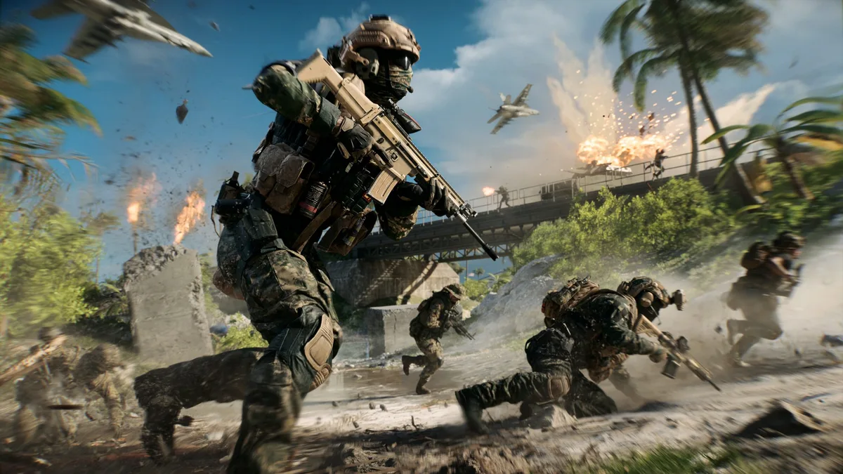 A soldier in military gear carrying a rifle runs across a battlefield with explosions and aircraft overhead in a scene from a game.