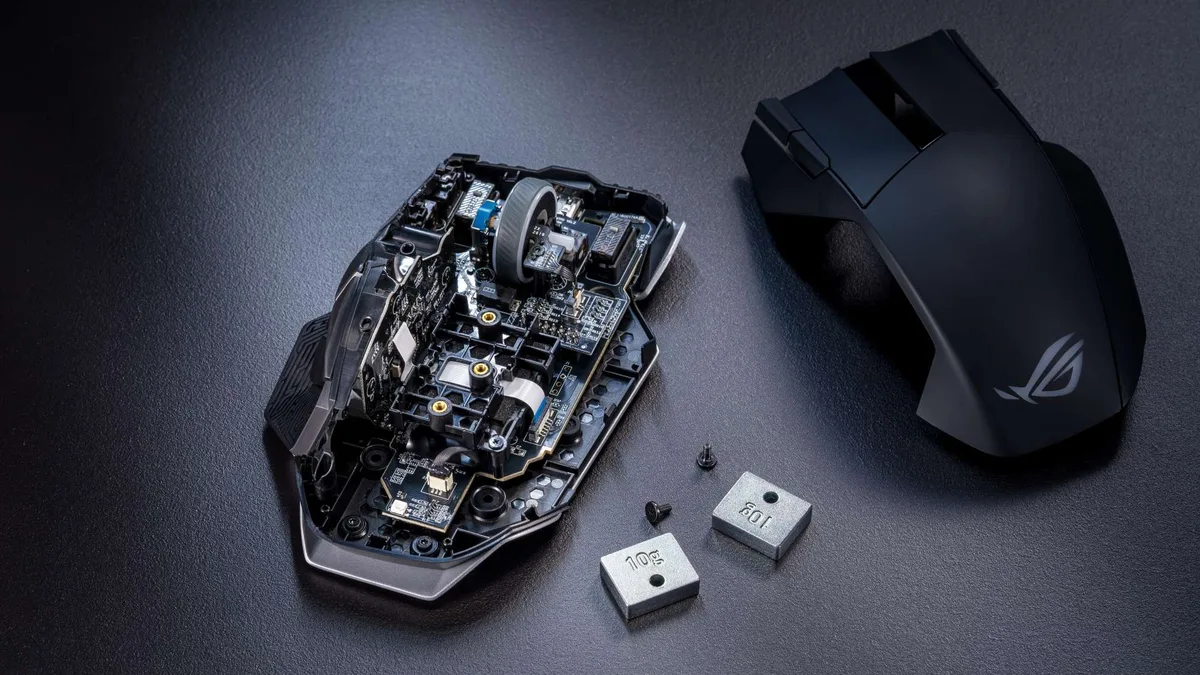 rog spatha x review — The ROG Spatha X 65K on a gray table, opened up with its internals on display.
