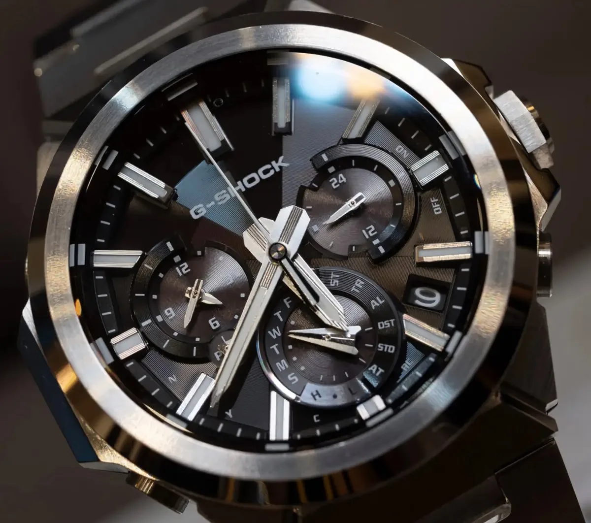 casio gst w1000 — Close-up of the black-dial Casio G-Shock GST-W1000D-1A, showing its three subdials, luminous hour markers, faceted hands, and multi-finish stainless steel bezel.