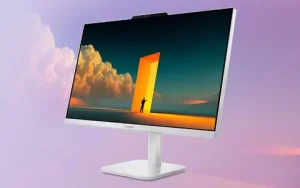 PC todo en uno Windows 11 — Ordenador todo en uno Lenovo A105 AIO con pantalla de bordes finos y fondo de escritorio artístico sobre un fondo degradado en tonos púrpura.