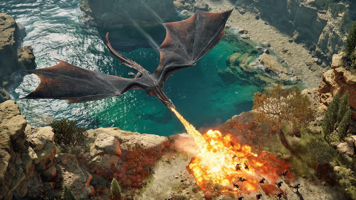 PlaySide Studios War Westeros — A dragon breathing fire onto a group of soldiers near a cliffside in the game Game of Thrones: War for Westeros.