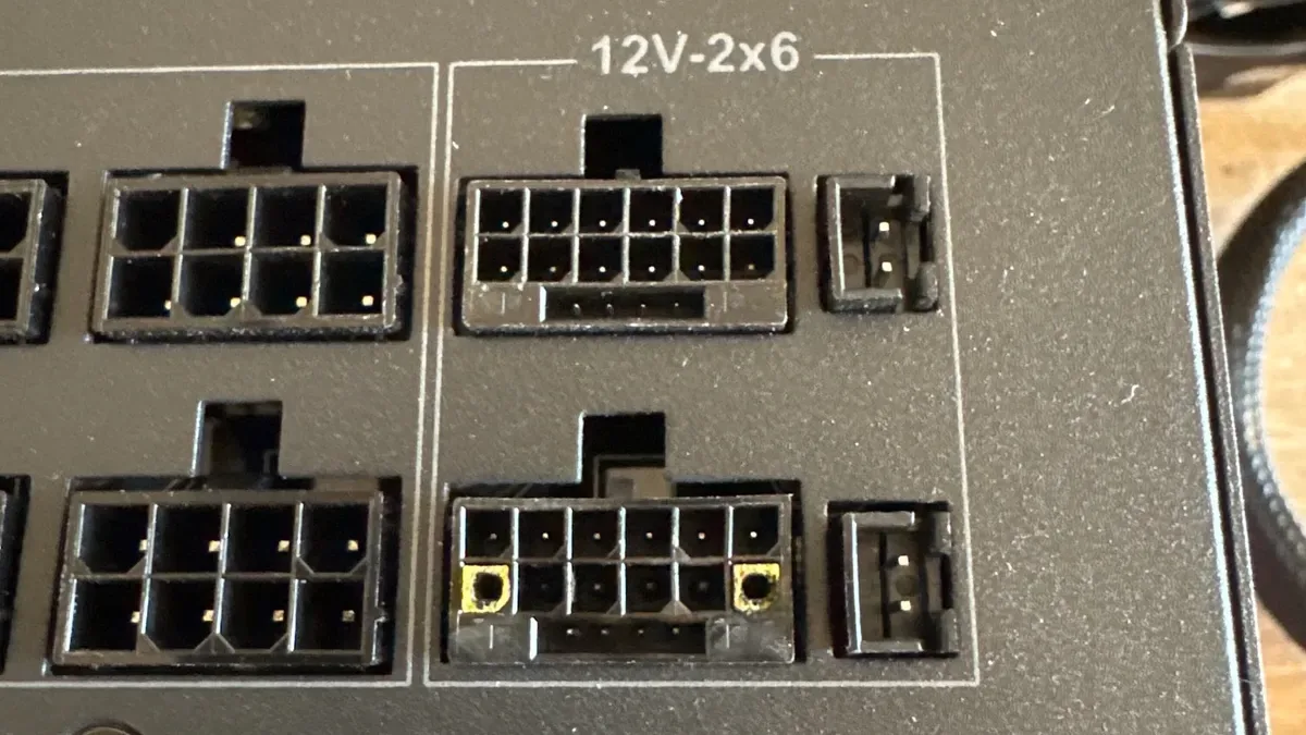 A photo showing a damaged 12V-2x6 connector on an ASRock power supply.