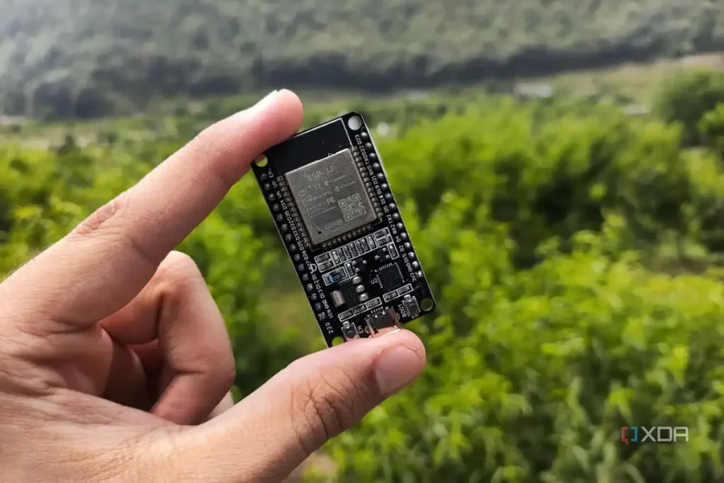 A person holding an ESP32 microcontroller