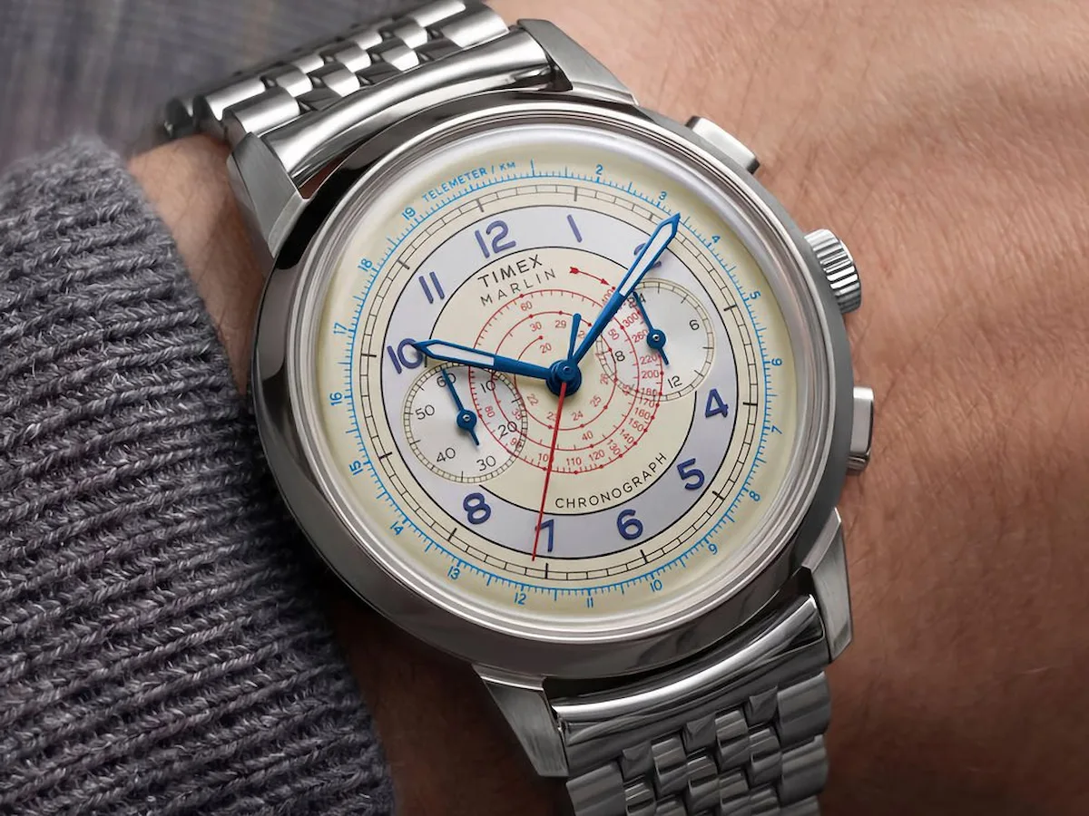 Timex Marlin Neo Classic Chronograph with a cream dial, blue hands, and stainless steel bracelet worn on a wrist.