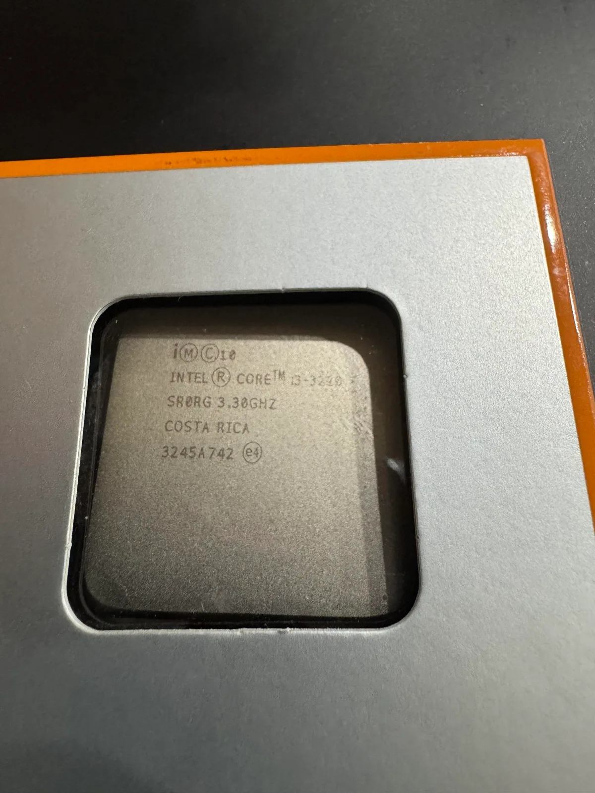 An Intel Core i3-3220 processor with'3.30GHz' and'COSTA RICA' stamped on its surface is seen in a packaging tray.