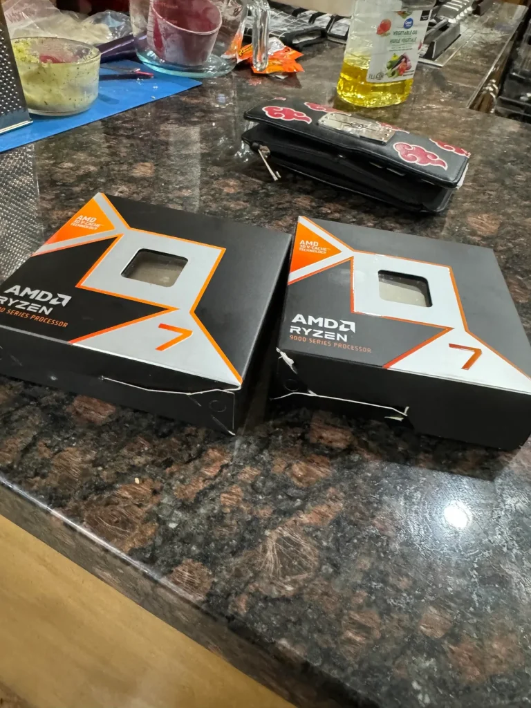 Two AMD Ryzen 9 9000 series processor boxes are placed on a kitchen countertop.