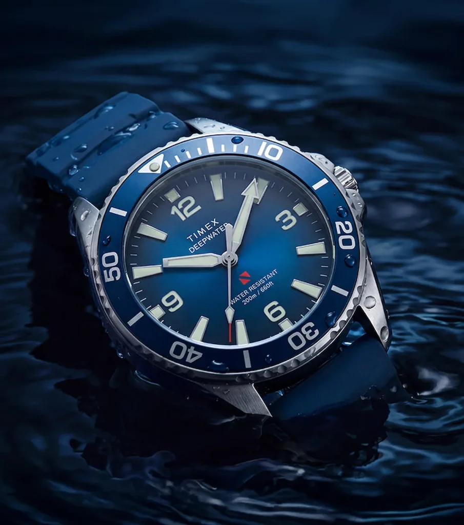 timex deepwater arctic 200m — Timex Deepwater Arctic 200 with a blue dégradé dial and matching blue HNBR rubber strap, photographed partially submerged in water.